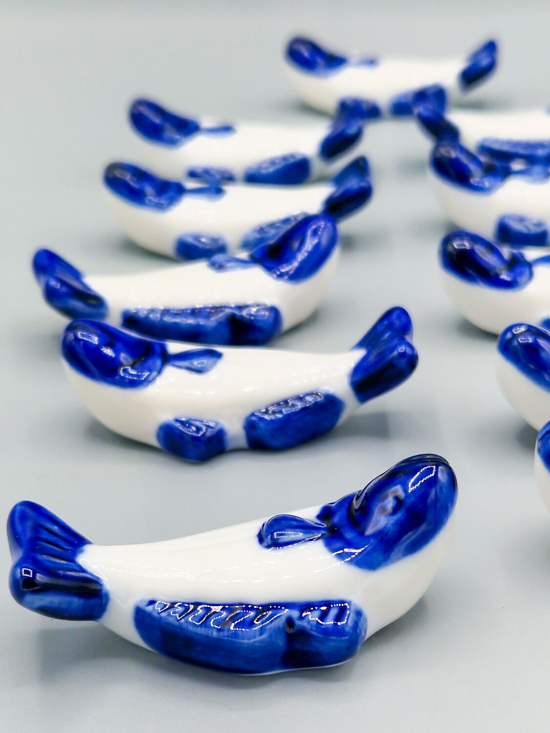 Set of 11 vintage blue and white porcelain fish knife rests.