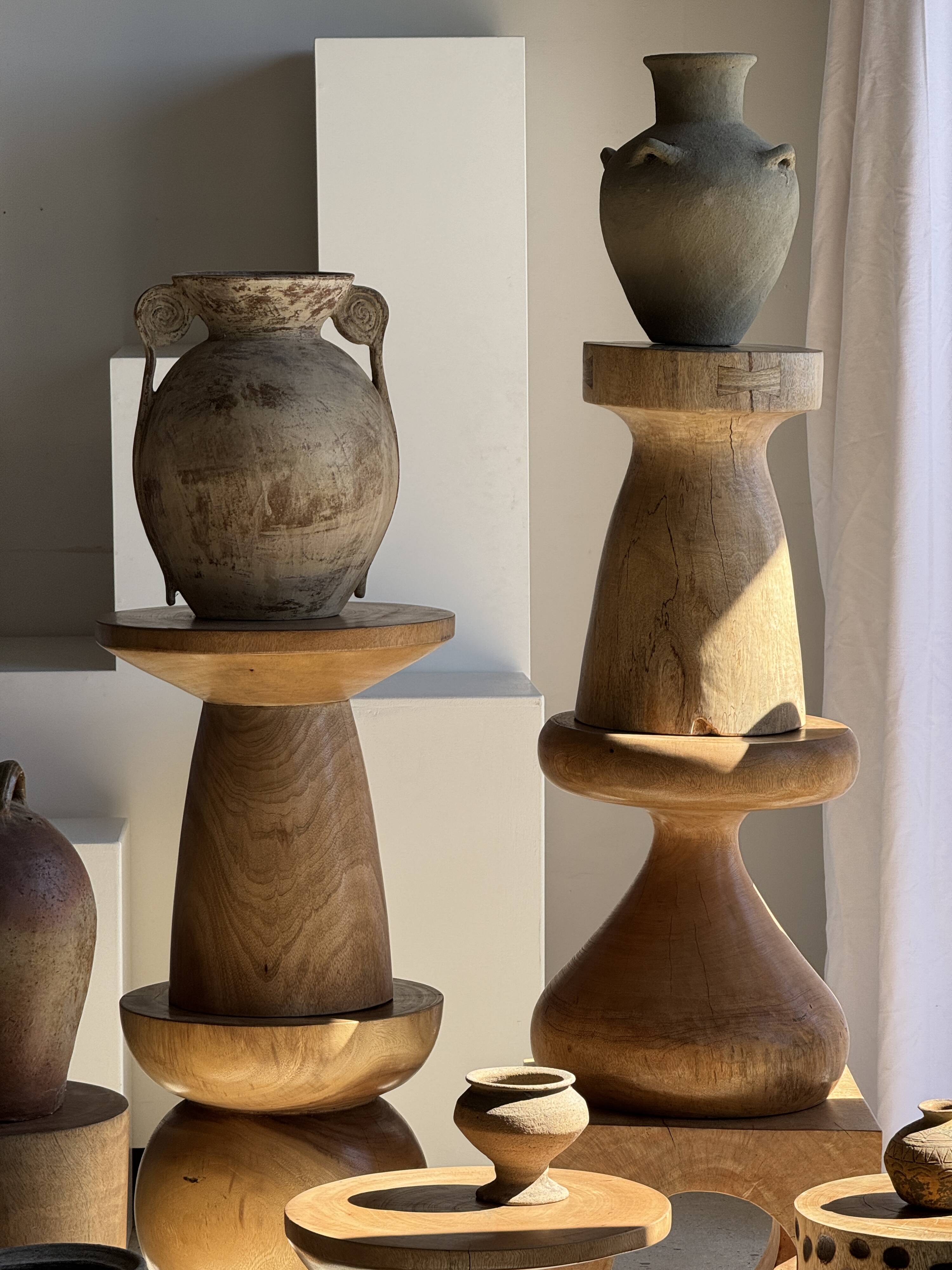 Natural solid mango side table (monoxyle) with conical legs.