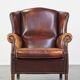 Comfortable, elegant, stately wing chair made of sheepskin in a beautiful warm color