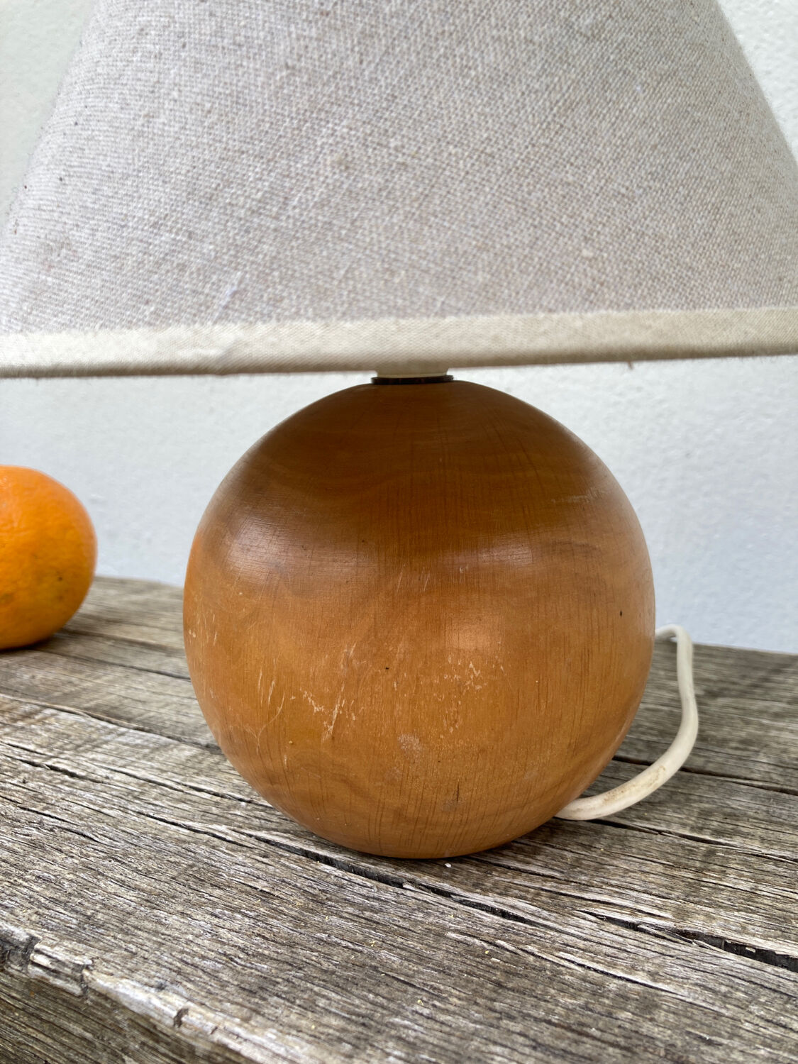 Wooden ball bedside lamp and beige lampshade
