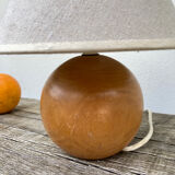 Wooden ball bedside lamp and beige lampshade