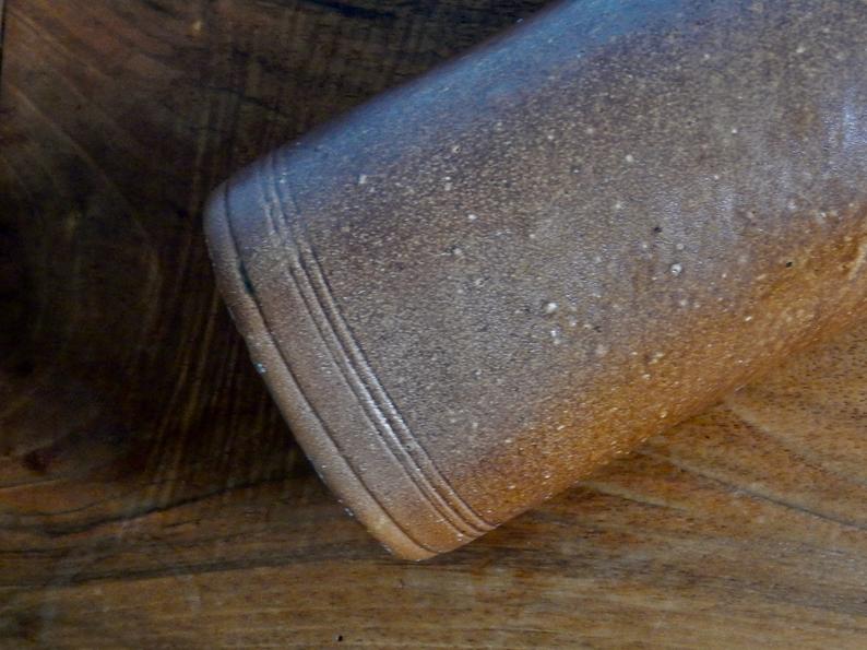 Enamelled brown sandstone bottle with handle