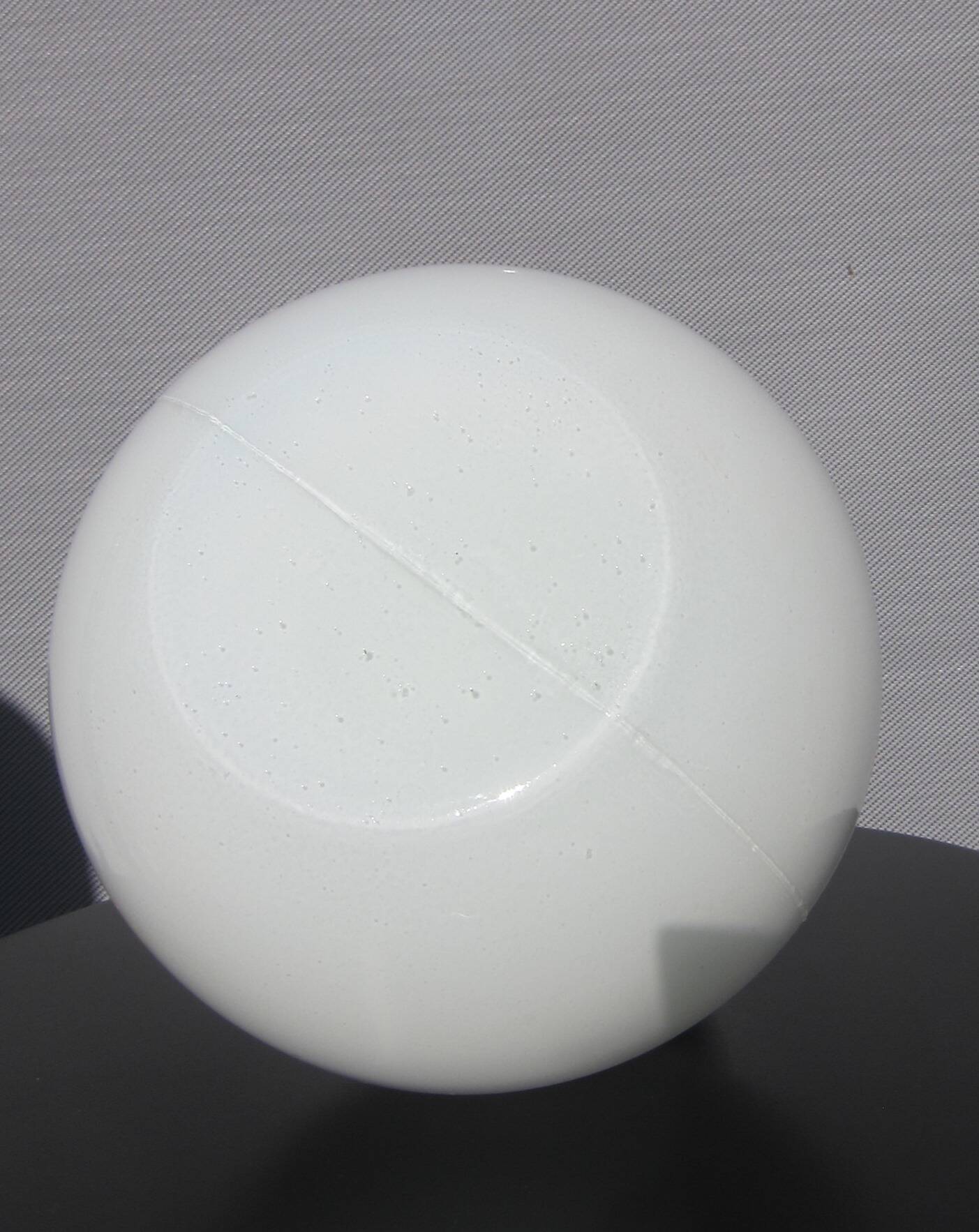 Trio of opal glass and bakelite globe pendant lights