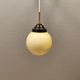 Small Art Deco hanging lamp in cream coloured glass and bakelite top.