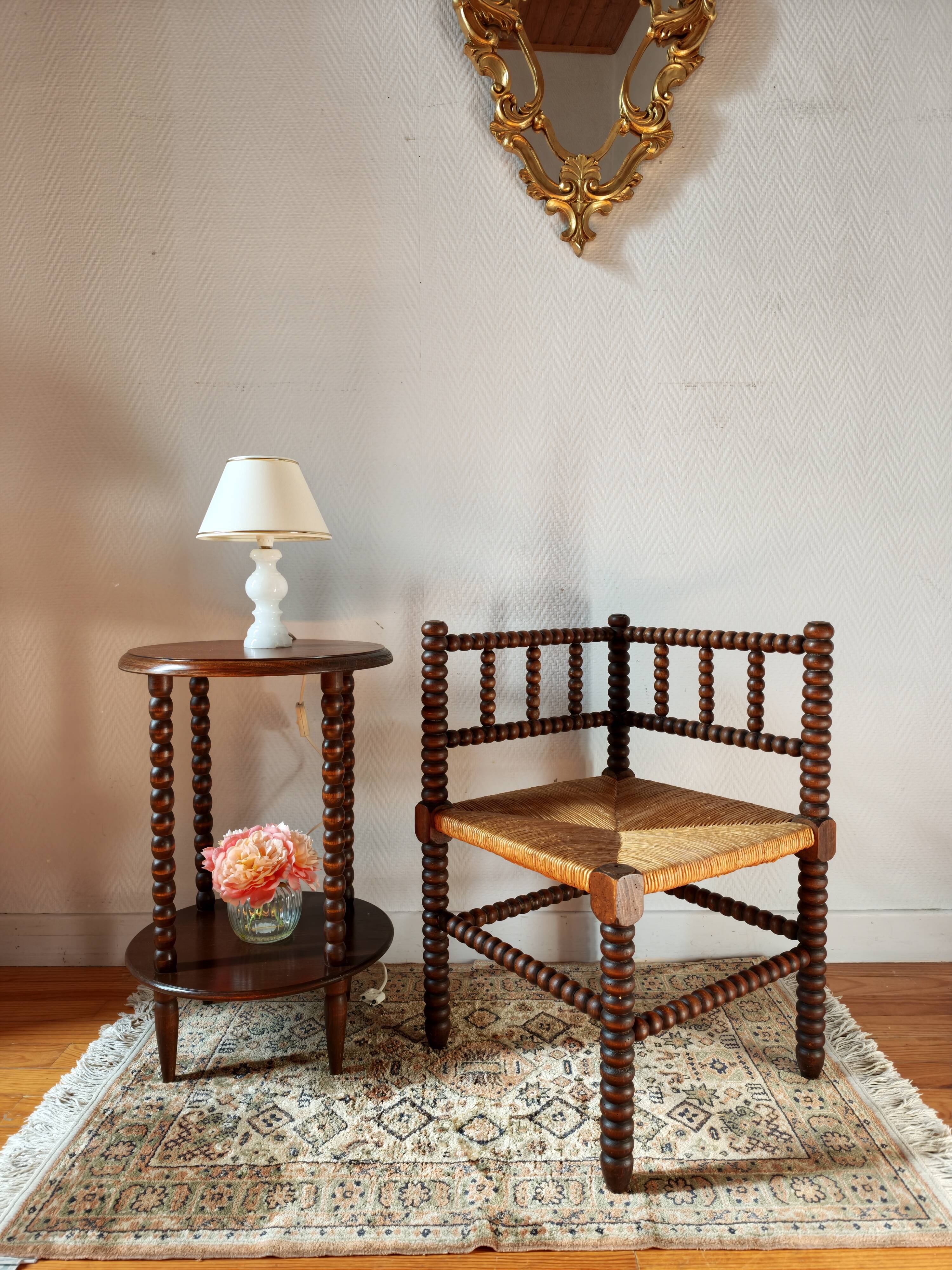 Old wooden turned spindle fireside chair with a straw seat.