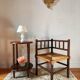 Old wooden turned spindle fireside chair with a straw seat.