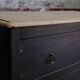 Black chest of drawers with 2 drawers, raw wood top and tapered legs