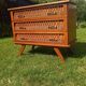 Rattan and wood splayed-leg chest of drawers