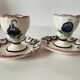 Pair of HB Quimper egg cups with integrated pedestal base, floral decoration