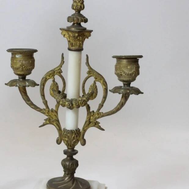 Clock and pair of Louis XVI style candelabras.