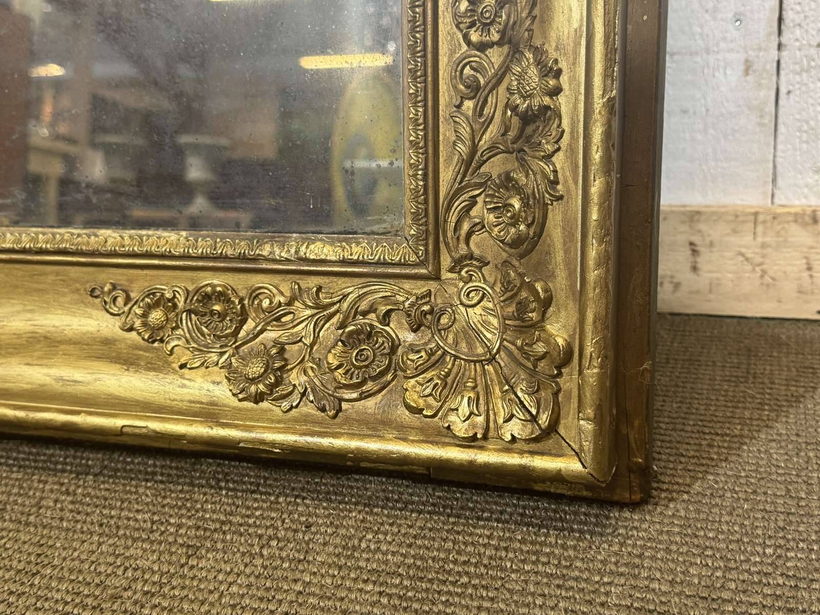 19th-century mirror in gilded wood and plaster.