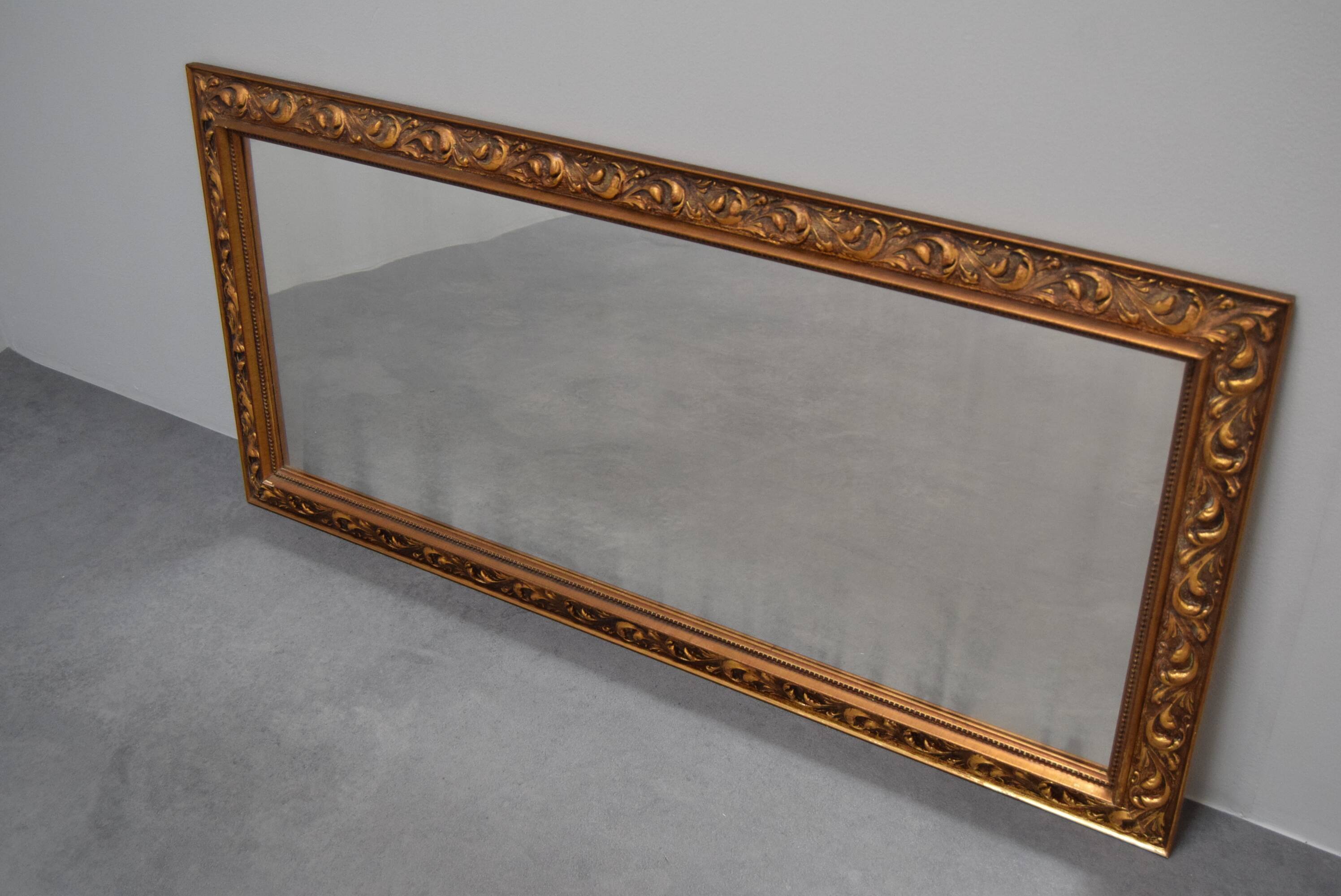 wall mirror in a decorative wooden frame.