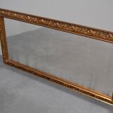 wall mirror in a decorative wooden frame.