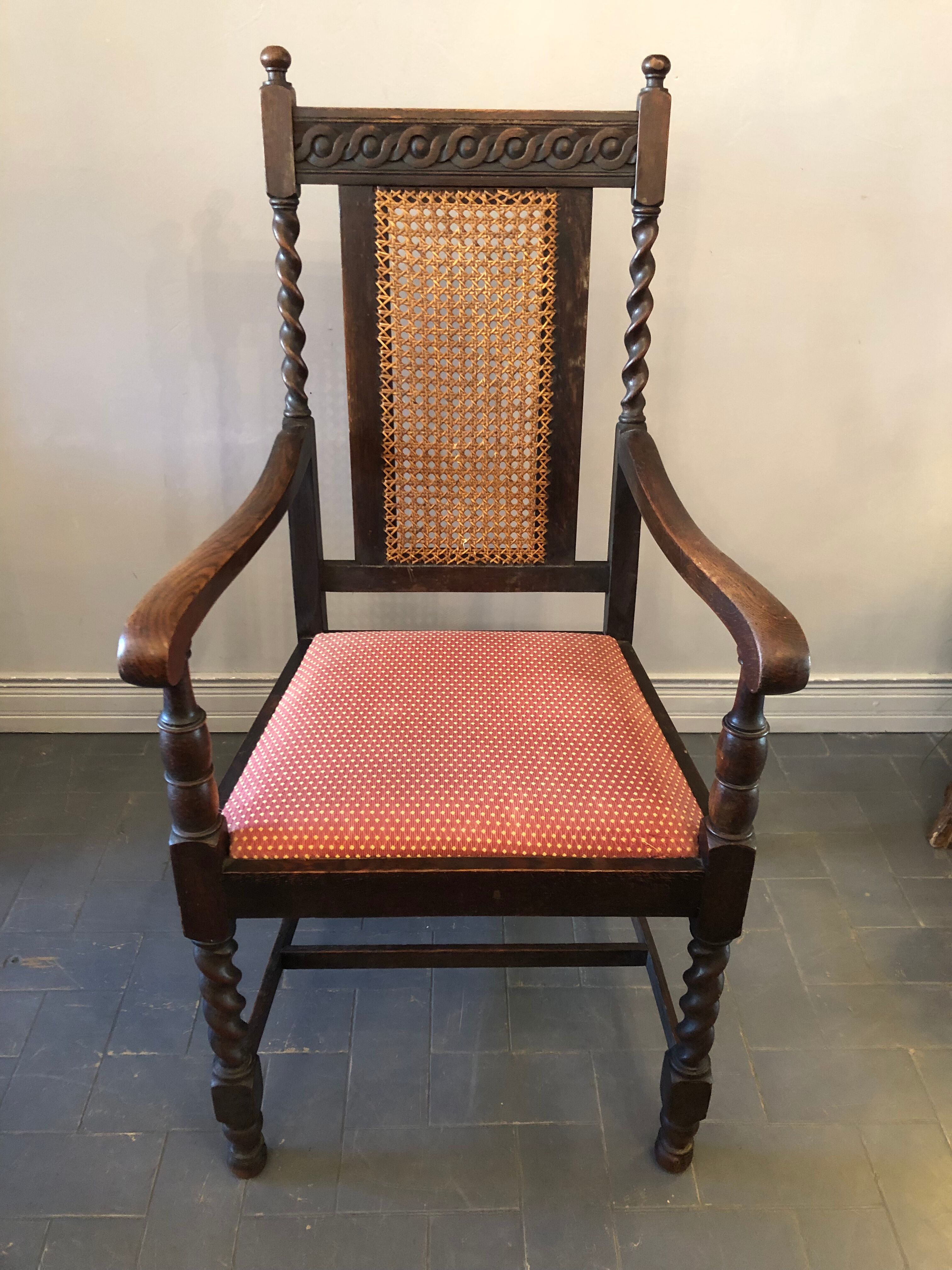 Carved wooden armchair and cannage
