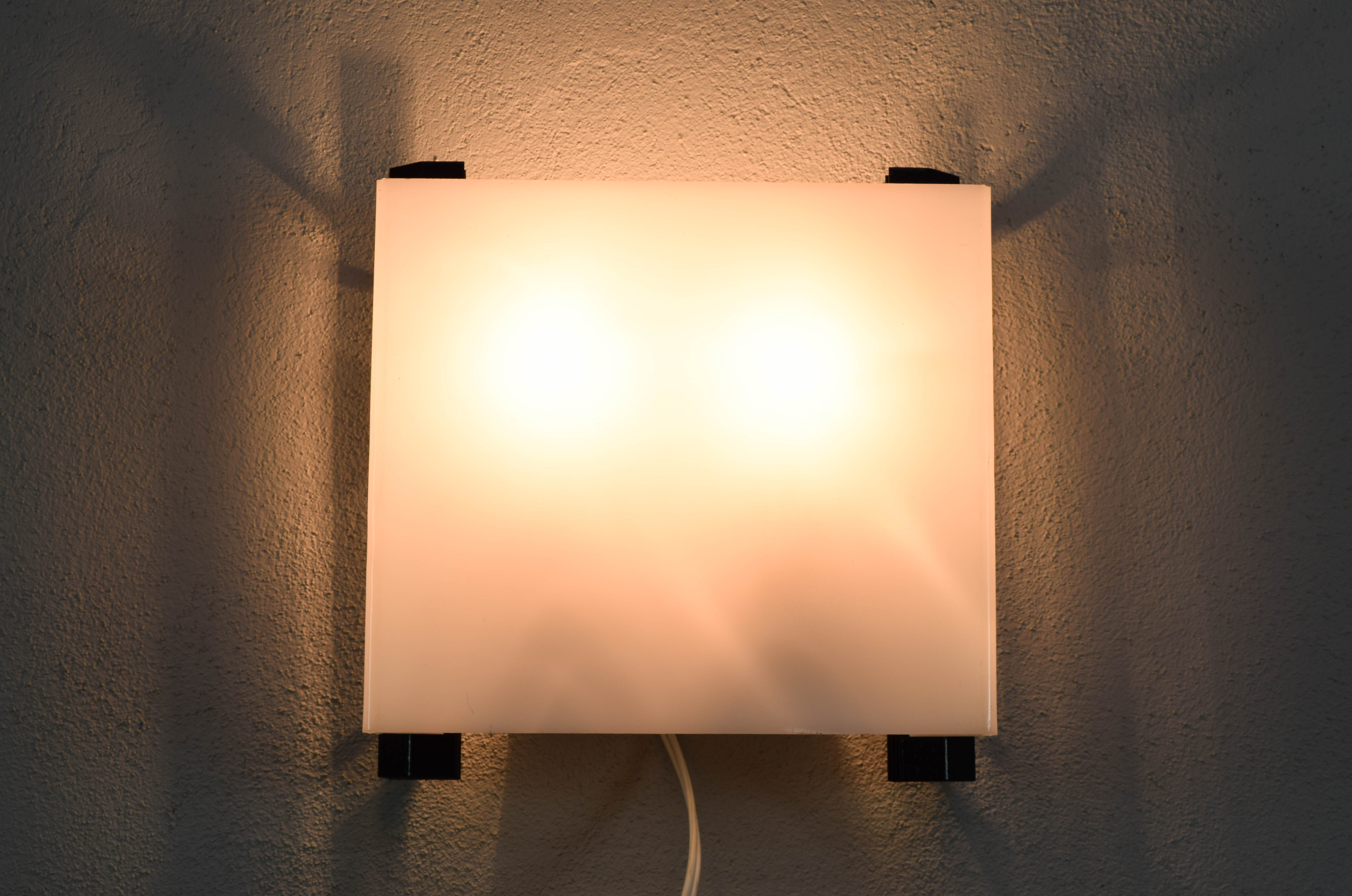 Mid-century modern sconces of black iron sheets and white lucite spain 1960s