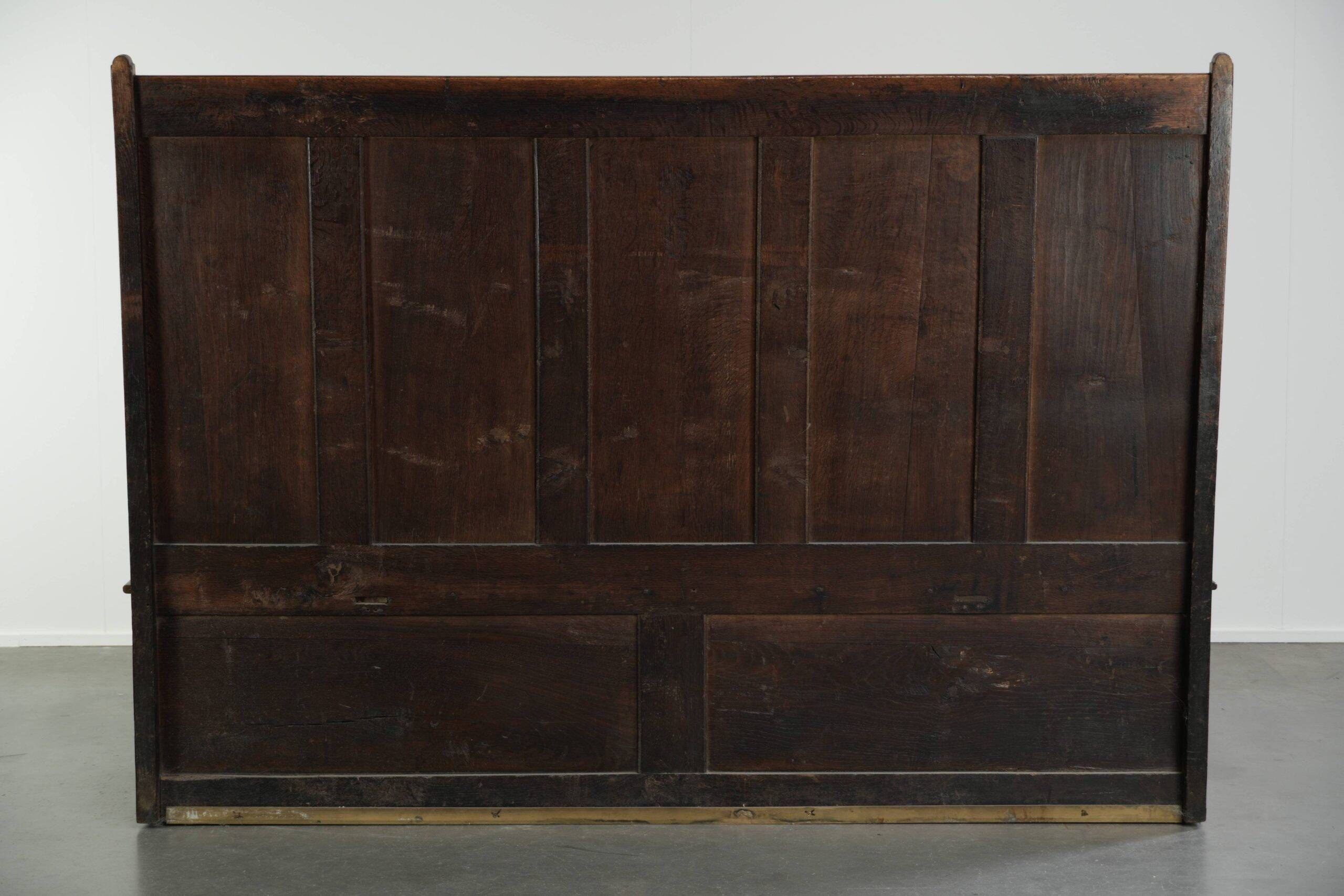 Antique English oak hall bench from the early 19th century with storage space