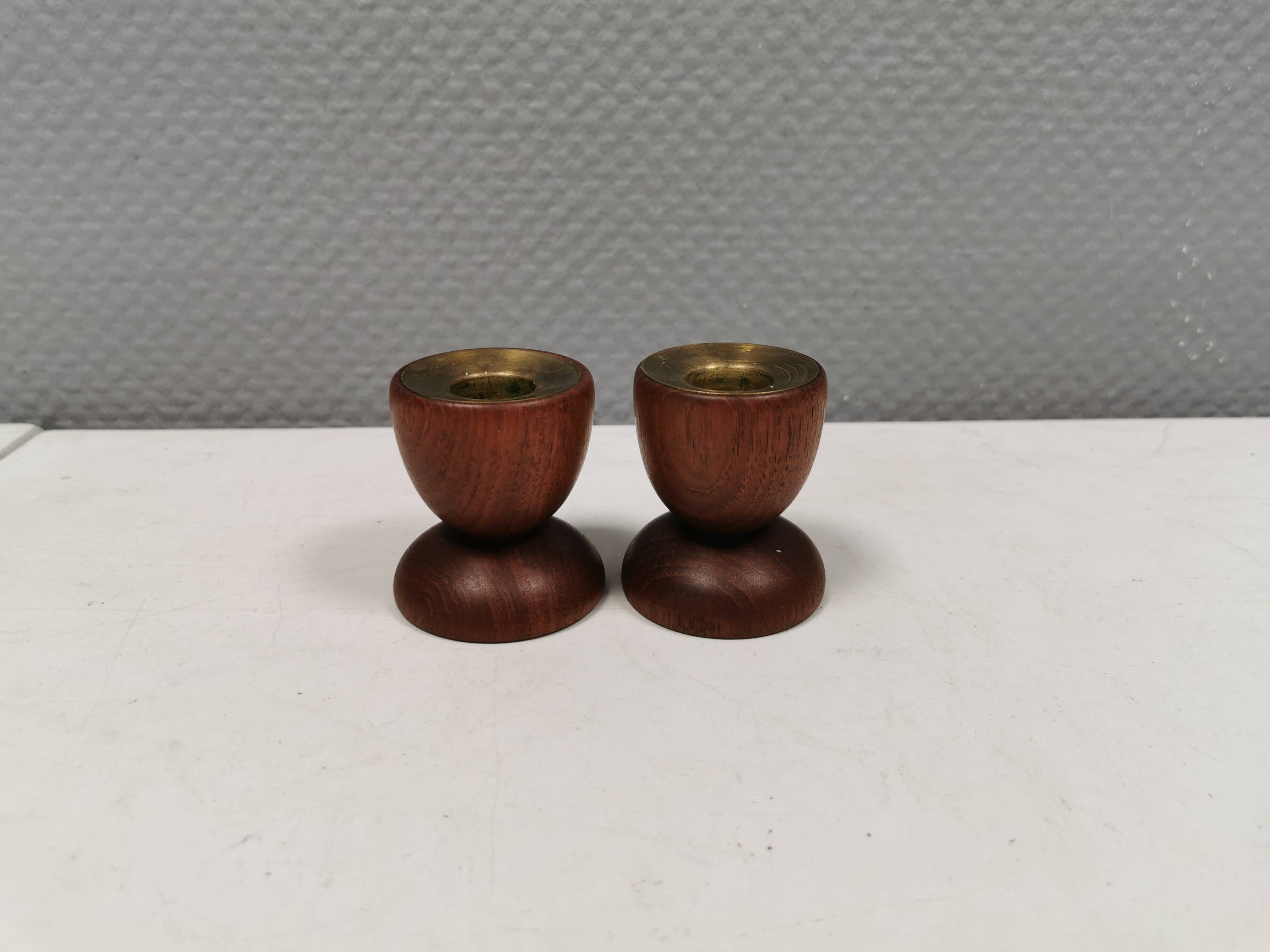 Two beautiful teak candle holders with brass inserts.