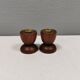 Two beautiful teak candle holders with brass inserts.