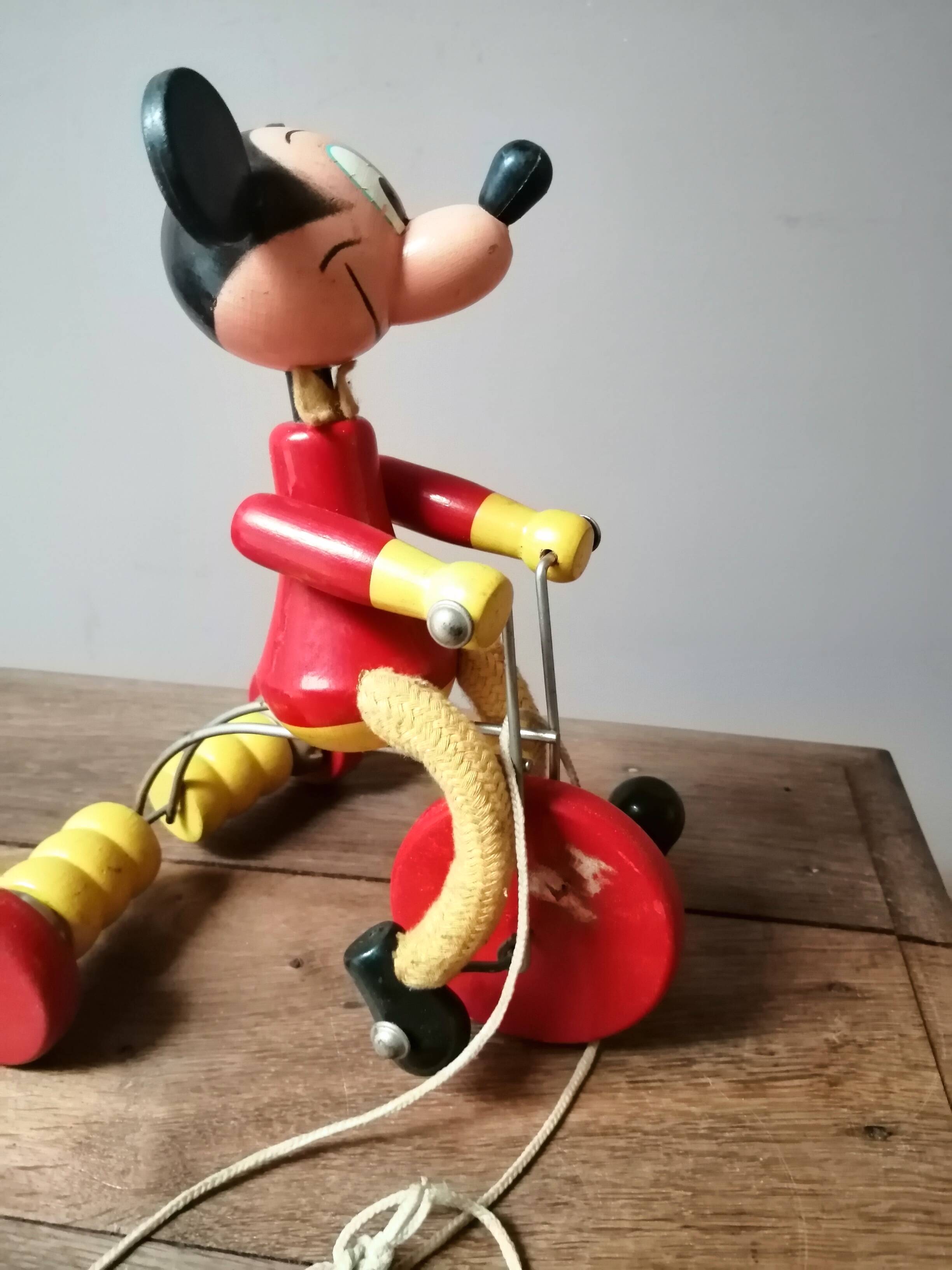 Old Mickey Mouse toy on his wooden tricycle
