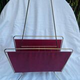 Vintage magazine rack in red skai with gold metal frame and plastic handle