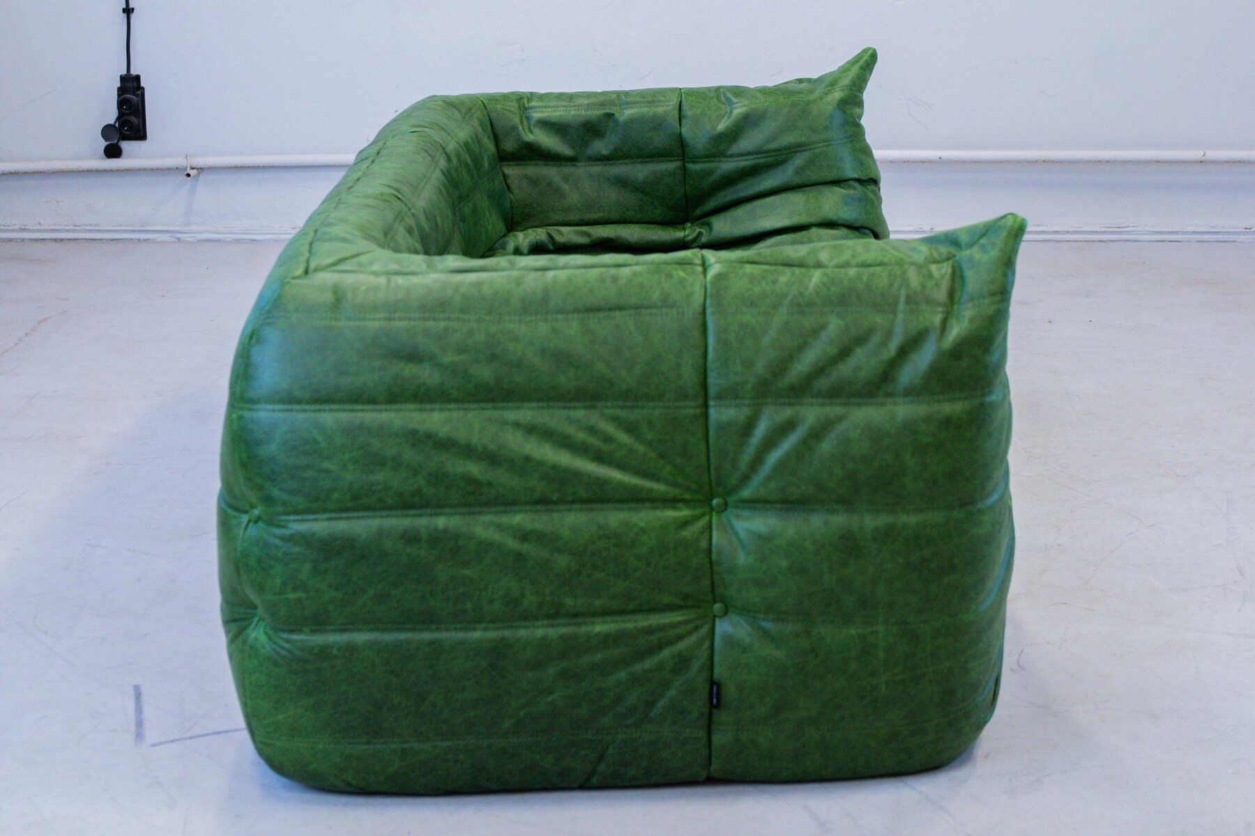 Vintage two-seat Togo sofa with arms in green leather by Michel Ducaroy for Ligne Roset, 1970s