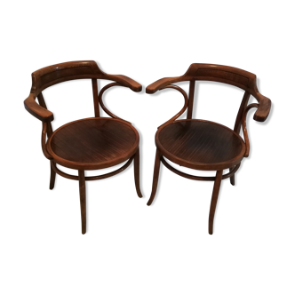 Pair of curved wooden armchairs