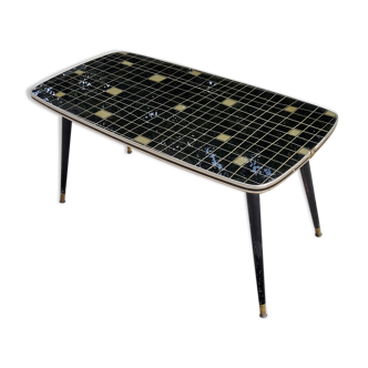 Coffee table of the 60s in glass and compass feet in blackened wood