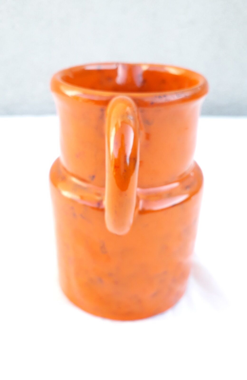 Orange ceramic pitcher