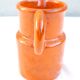 Orange ceramic pitcher