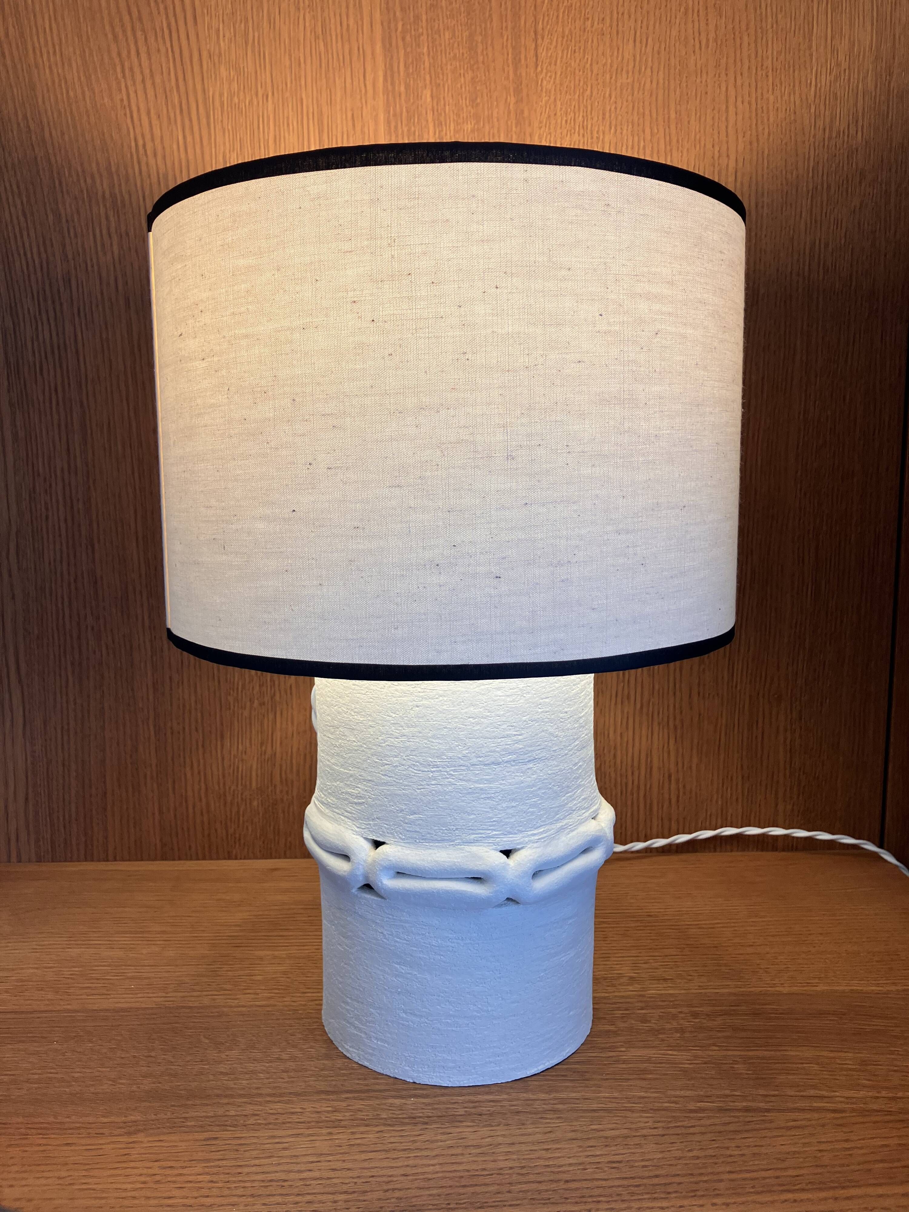 Table lamp in ceramic with a handmade couture-style lampshade from France.
