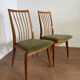 Scandinavian chairs with green velvet upholstery.