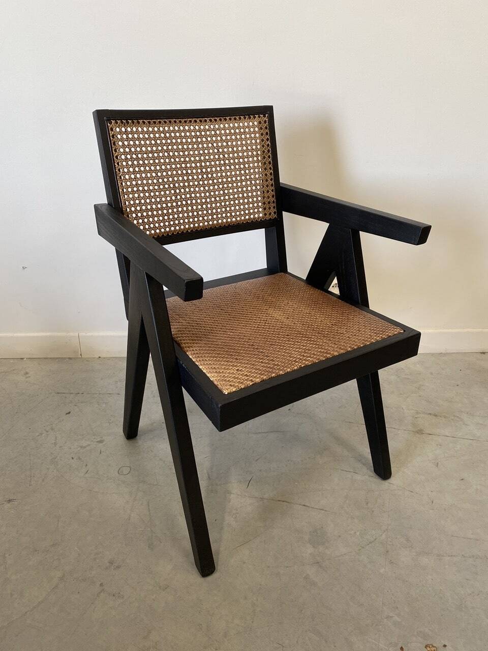 Black wooden armchair with caning