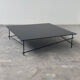 Minimalist black glass coffee table with industrial metal base