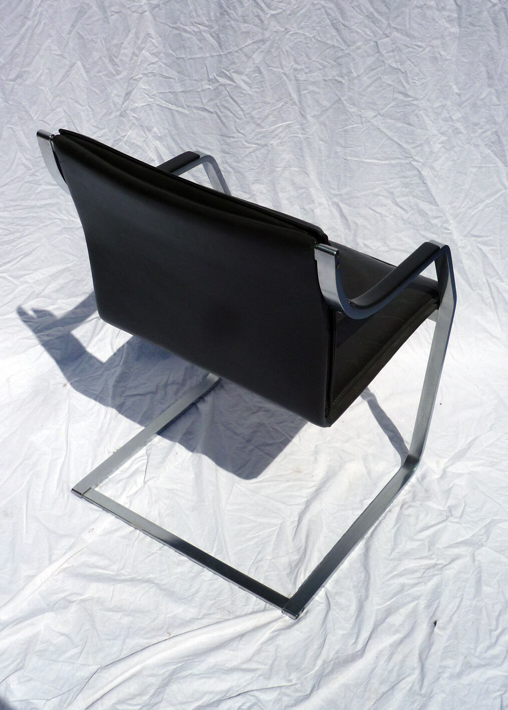 Chair with steel and leather armrests