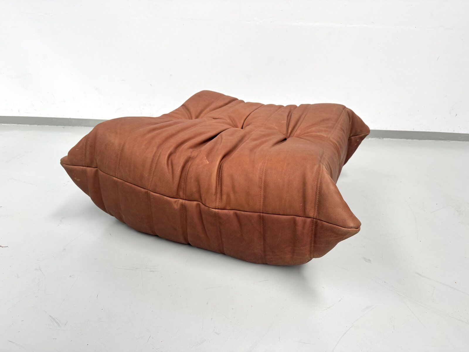 French Togo ottoman in cognac neck leather attributed to Michel Ducaroy for Ligne Roset