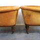 Unique old set of 2 club armchairs and a couch in cognac-colored leather with wheels