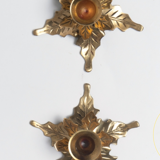 Two candlesticks in holly leaves