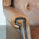 Large and comfortable sheepskin leather wingback chair with black piping