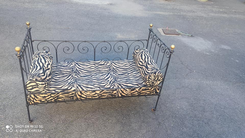 Lit d'enfant transformé en banquette en fer forgé sur roulettes