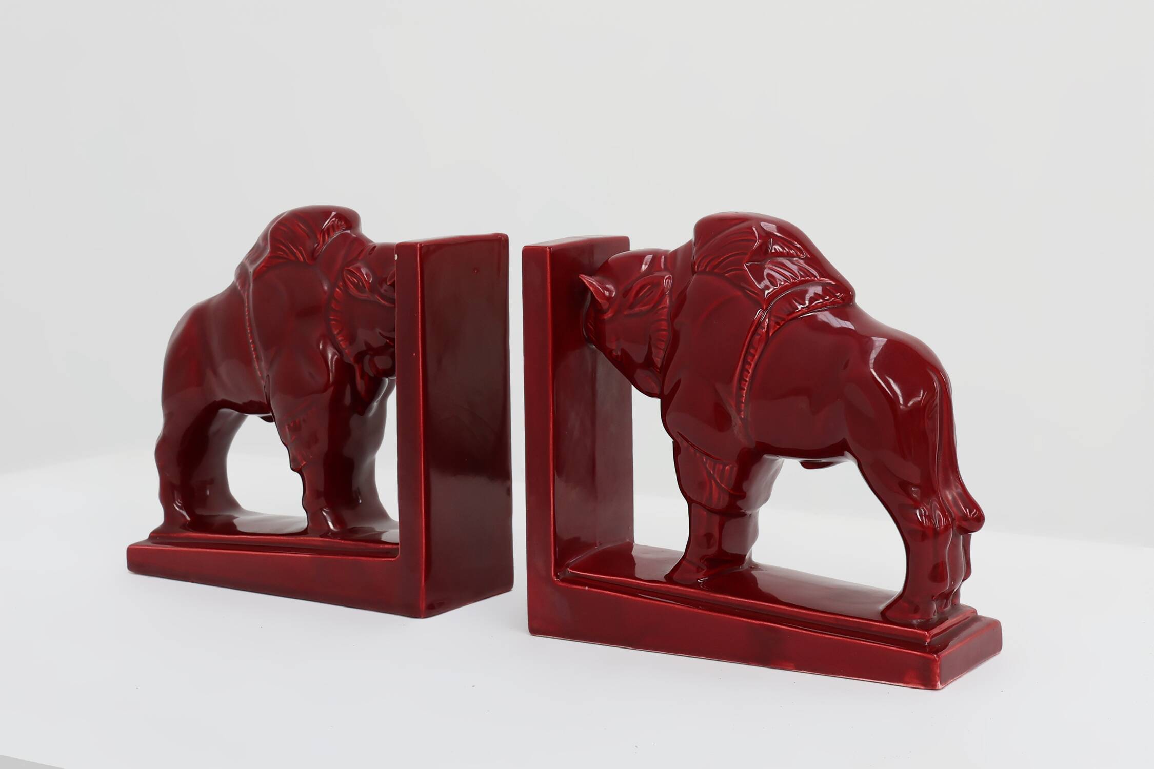 Pair of red glazed ceramic Bison ox bookends in Art Deco style, Belgium