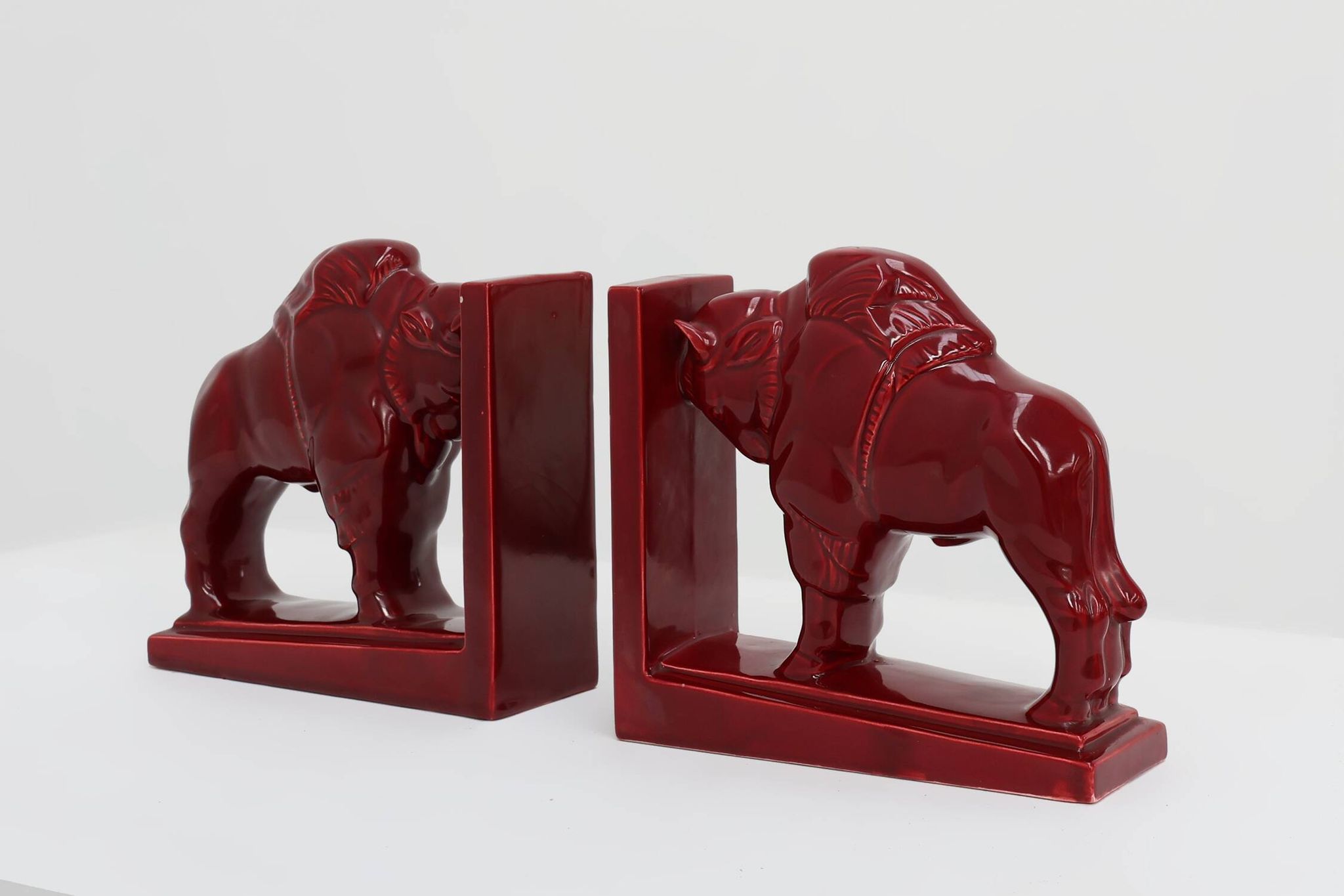 Pair of red glazed ceramic Bison ox bookends in Art Deco style, Belgium