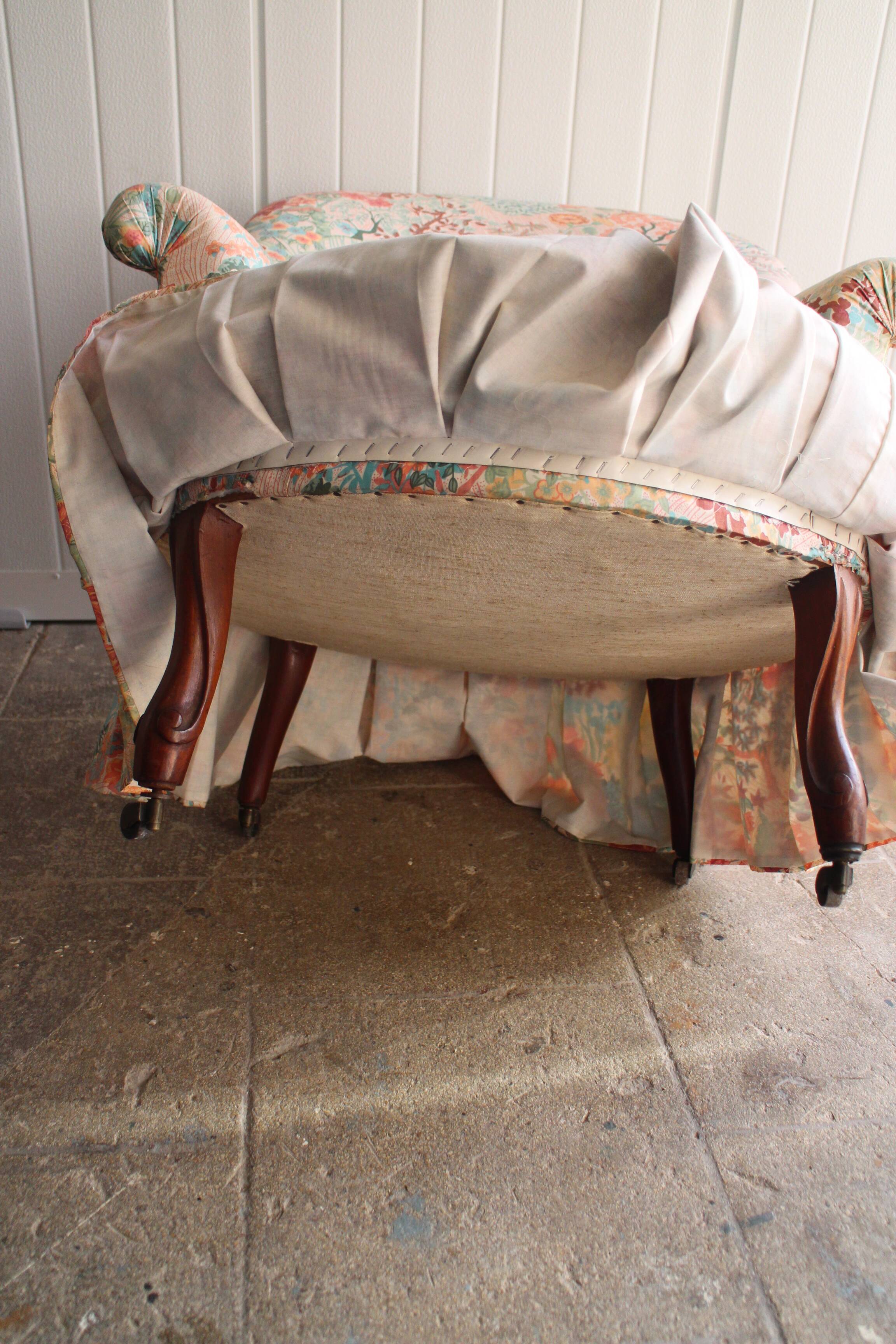 pair of toad armchairs in floral fabric.