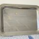Vintage stainless steel serving platter with marine decor and golden handles.