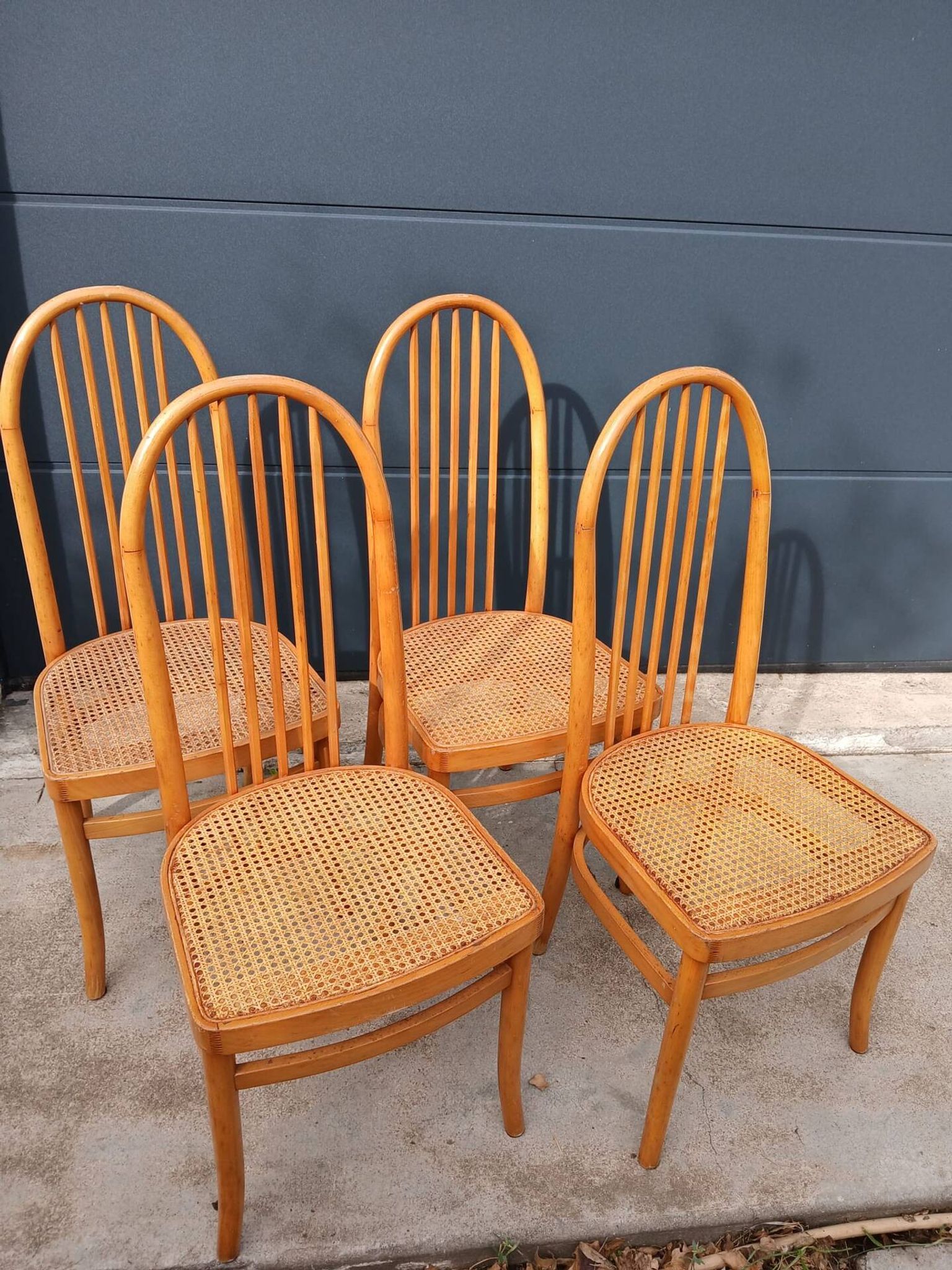 Set of 4 vintage Baumann chairs in honey wood and cane.