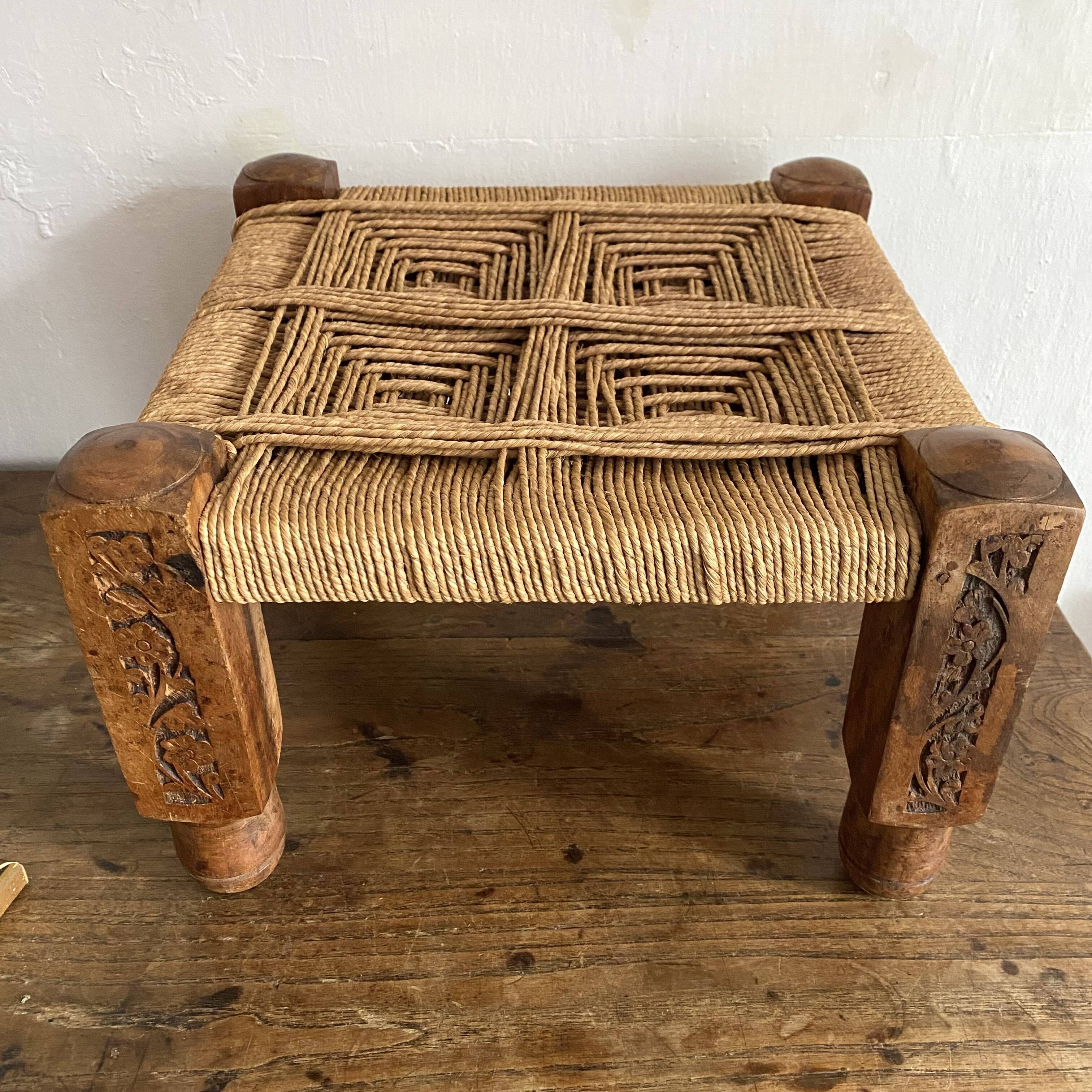 Low stool with carved wood and braided cord.