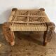 Low stool with carved wood and braided cord.