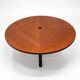 Large round dining table with black blade legs.