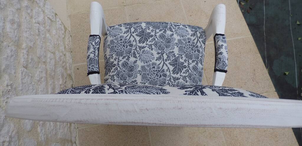 Voltaire style armchair covered in floral fabric in quality aged wood