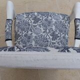 Voltaire style armchair covered in floral fabric in quality aged wood