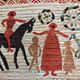 Vintage handwoven tapestry with a folk scene and archaic Slavic writing.